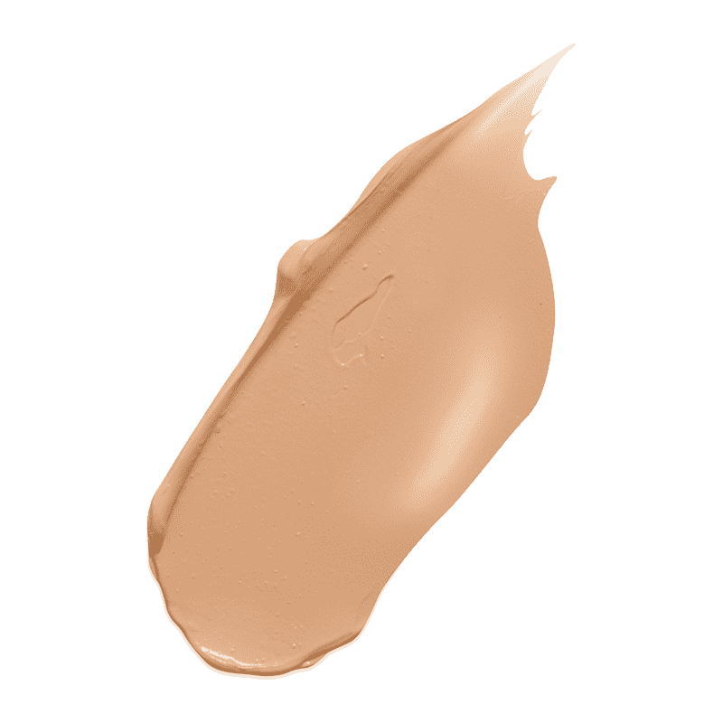 Beige Concealer Swatch auf grünem Hintergrund.