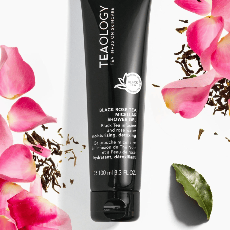 TEAOLOGY Black Rose Tea Micellar Shower Gel 100ml, umgeben von Rosenblättern und Teeblättern.