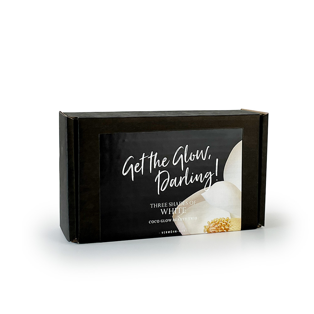 Schwarze Verpackung mit der Aufschrift 'Get the Glow, Darling! Three Shades of White Coco Glow'.