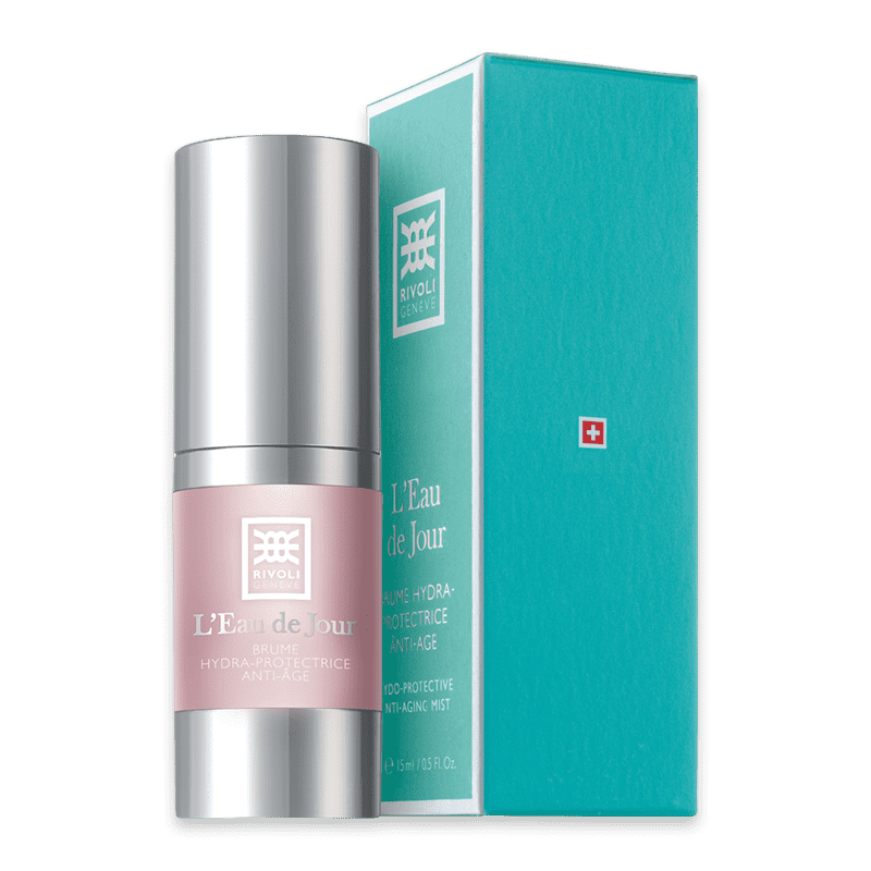 Rivoli Genève L'Eau de Jour Anti-Aging-Mist 15ml, silberne Flasche mit rosa Etikett, grüne Verpackung mit weißem Logo und rotem Kreuz.
